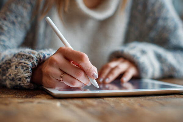 close_up_of_a_woman_s_hands_writing_on